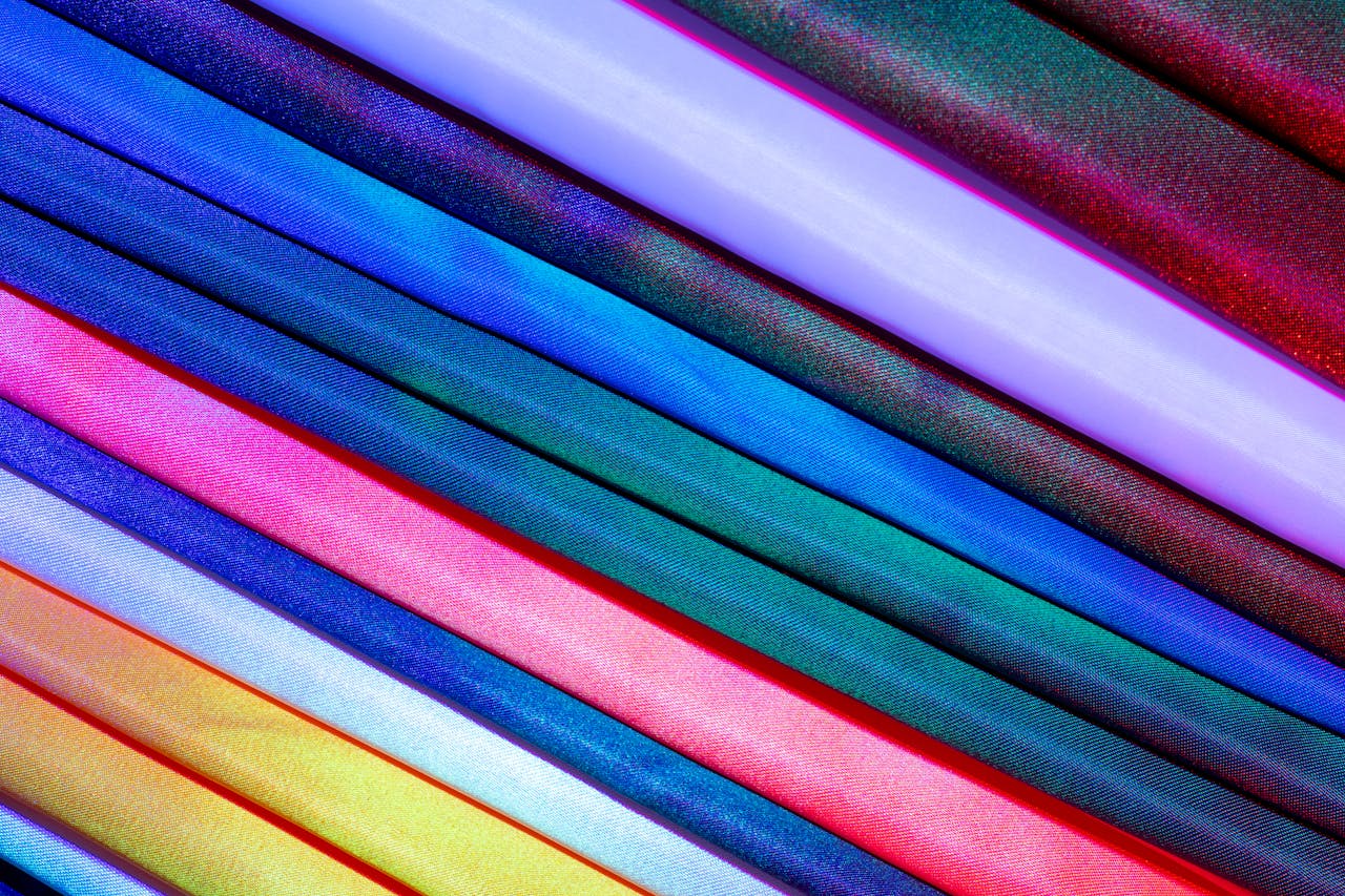 about-02 Abstract view of multicolored fabric, showcasing vibrant stripes and textures.